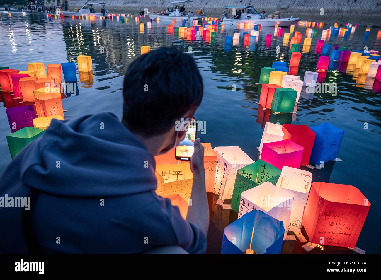 Le persone galleggiano lanterne sul fiume, di fronte all'Atomic Bomb Dome con lampade galleggianti sul fiume Motoyasu-gawa durante la cerimonia commemorativa della pace ad Augusto Foto Stock