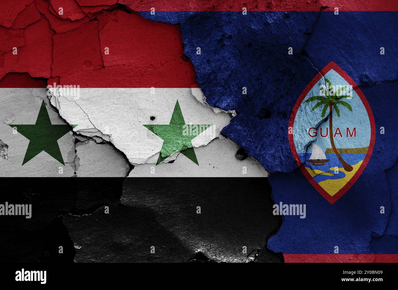 Bandiere di Siria e Guam dipinte su pareti incrinate Foto Stock