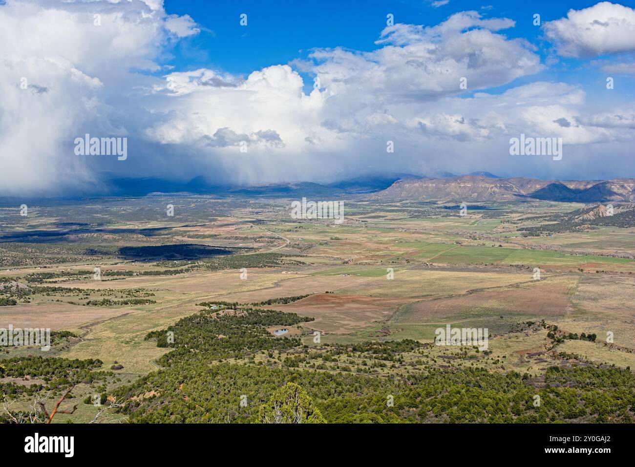 Panoramica delle ampie pianure verdi della valle di Montezuma con una doccia primaverile che passa dalla cima di mesa al Parco Nazionale di mesa Verde Foto Stock