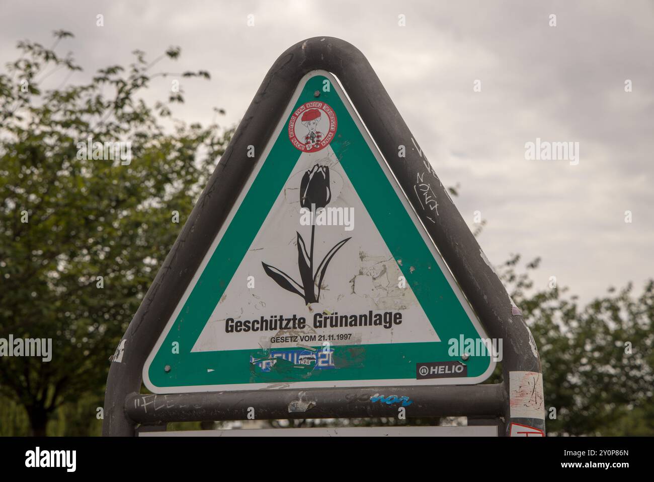 Il cosiddetto Tulip-sign tedesco: Segno triangolare "Geschützte Grünanlage" (area verde protetta) a Berlino, Germania Foto Stock