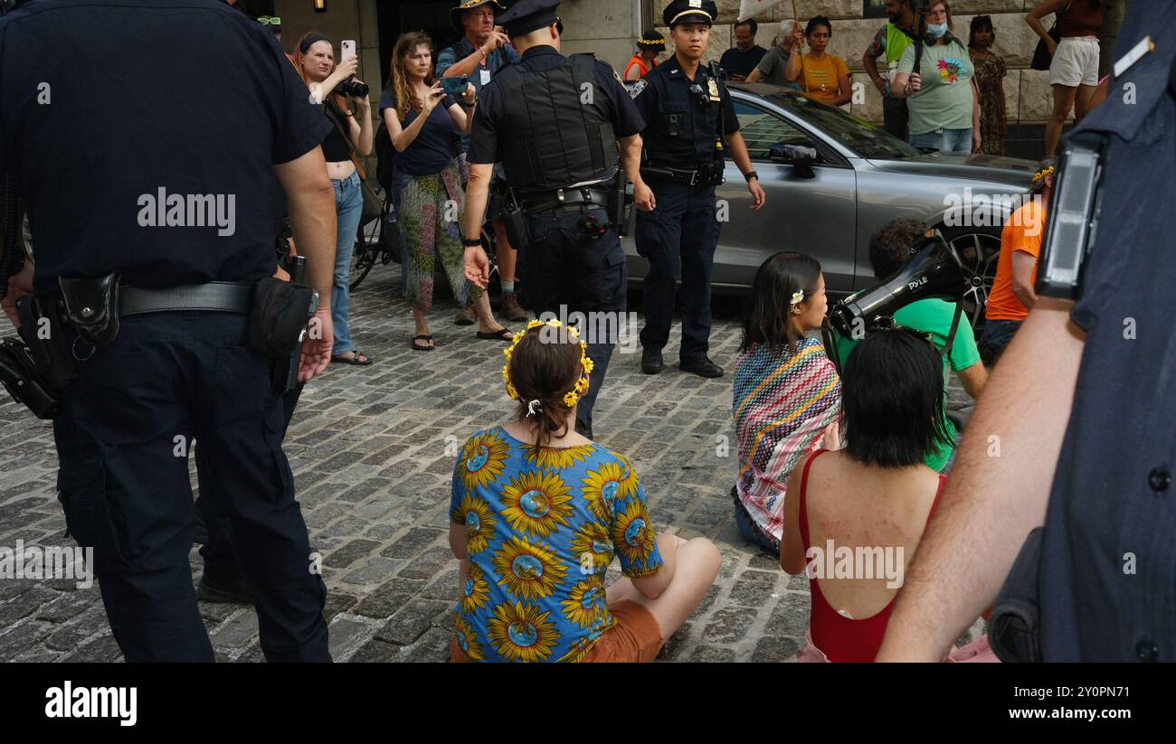 New York, Stati Uniti. 26 agosto 2024. Gli agenti di polizia arrestano gli attivisti durante la marcia "Feminist Fight Fossil Fuels”. I manifestanti si riunirono fuori dalla fabbrica di magliette Triangle e marciarono per tutta Lower Manhattan passando per molti negozi commerciali. La polizia è stata informata e ha arrestato molti dei manifestanti che hanno bloccato la strada fuori dall'appartamento Jane Fraser a New York. (Foto di Susan Stava/SOPA Images/Sipa USA) credito: SIPA USA/Alamy Live News Foto Stock