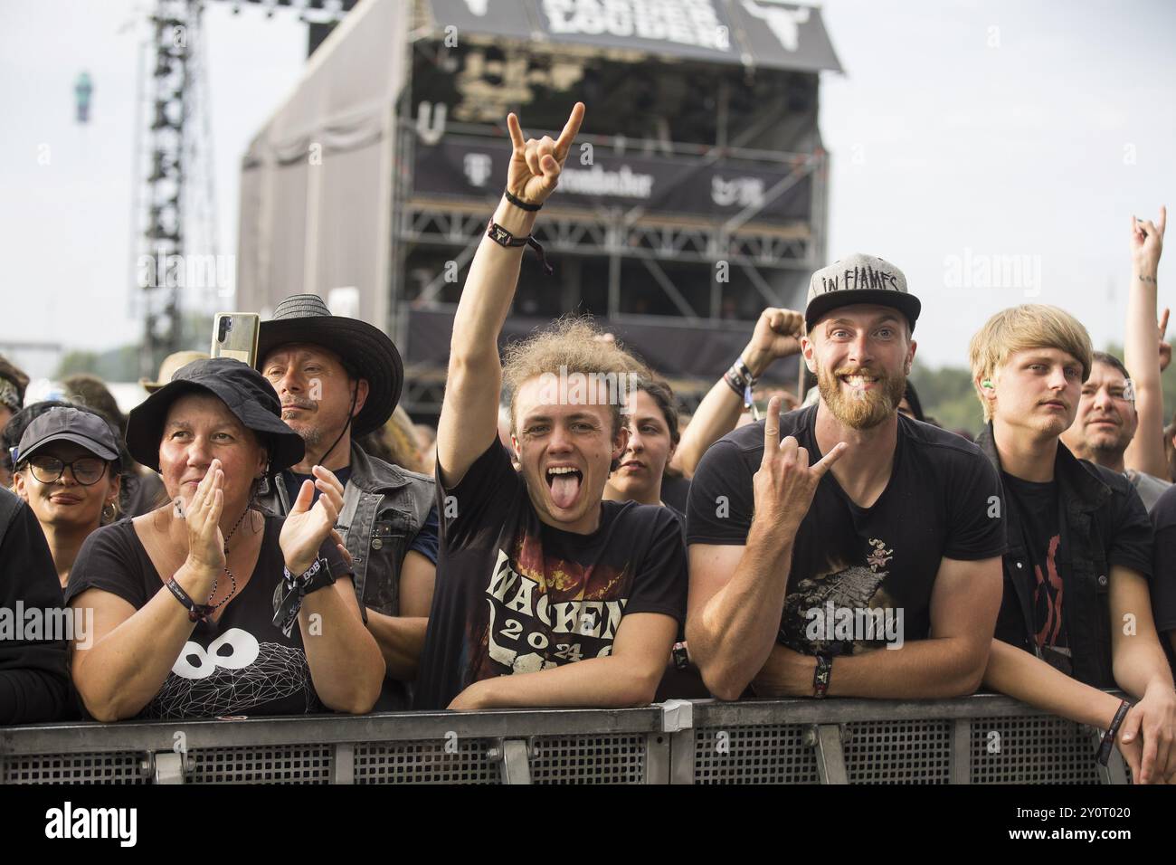 I visitatori del festival salutano il diavolo al Wacken Open Air di Wacken. Il tradizionale festival del metal si svolge dal 31 luglio al 3 agosto 2024 Foto Stock