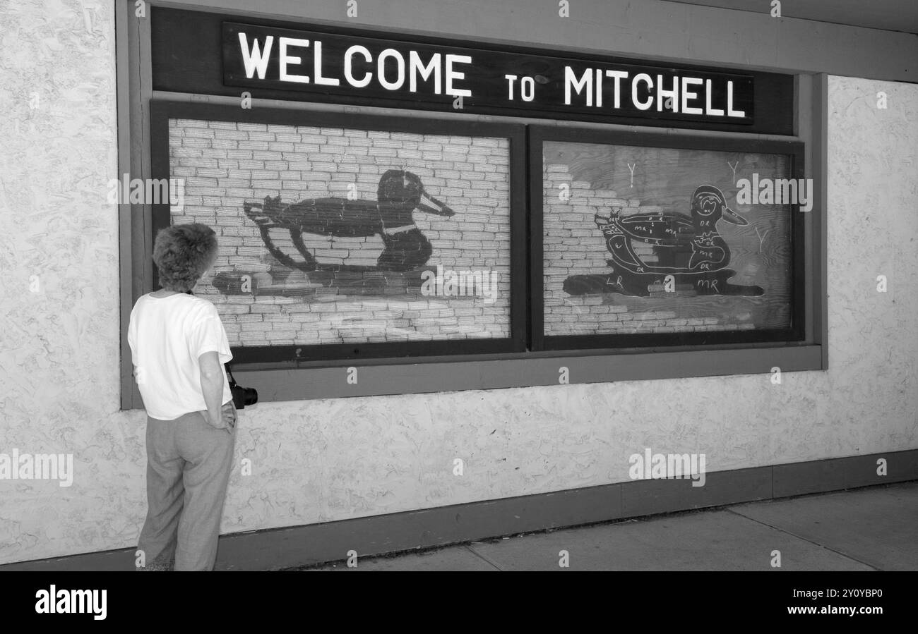 Donna turistica caucasica che guarda il cartello "Welcome to Mitchell" al Corn Palace Convention & Visitors Bureau di Mitchell, South Dakota. STATI UNITI Foto Stock