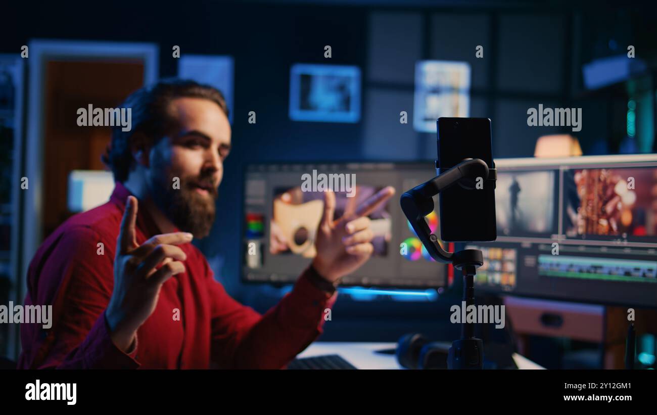 Smartphone su treppiede utilizzato dal videografo per insegnare agli spettatori di Internet a creare effetti visivi per i progetti video. Esercitazione online esperta sulle riprese con il telefono cellulare sull'editing dei filmati Foto Stock