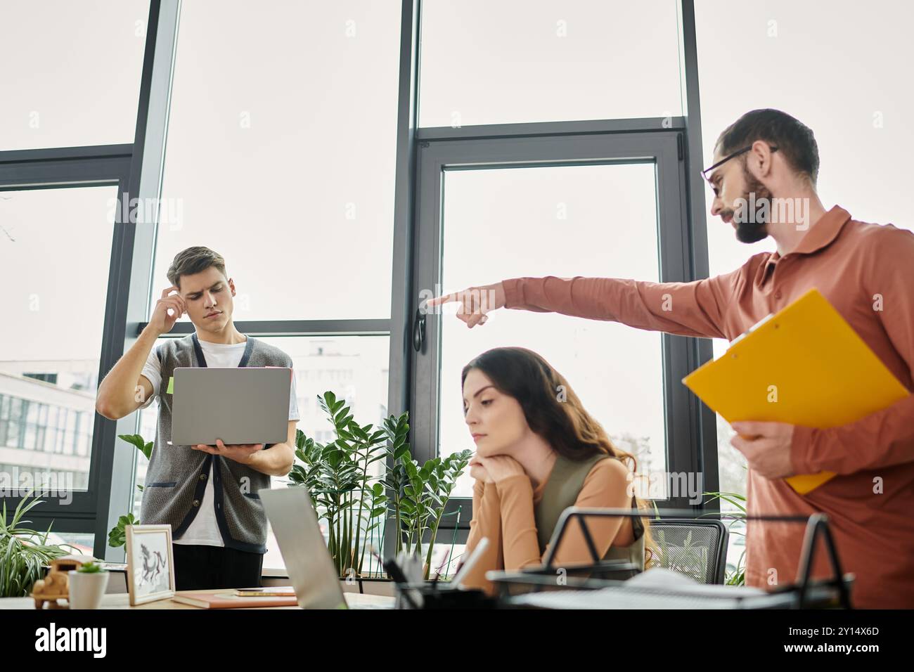 Professionisti impegnati in una discussione tesa sul posto di lavoro. Foto Stock