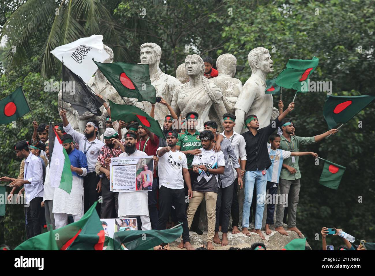 Marcia Shahidi a Dacca i manifestanti ondeggiano la bandiera nazionale del Bangladesh durante la marcia martiriana, una manifestazione organizzata dagli studenti contro la discriminazione per celebrare un mese per l'estromissione dell'ex primo ministro Sheikh Hasina, a Dacca il 5 settembre 2024. Il Premier deposto del Bangladesh Sheikh Hasina dovrebbe tacere mentre era in esilio in India fino a quando non viene portata a casa per il processo, il leader ad interim Muhammad Yunus ha detto ai media indiani il 5 settembre. Hasina, 76 anni, fuggì in India in elicottero un mese fa mentre i manifestanti marciavano sul suo palazzo in una drammatica fine al suo dominio pugno di ferro di 15 anni. Dhaka Dhaka Foto Stock