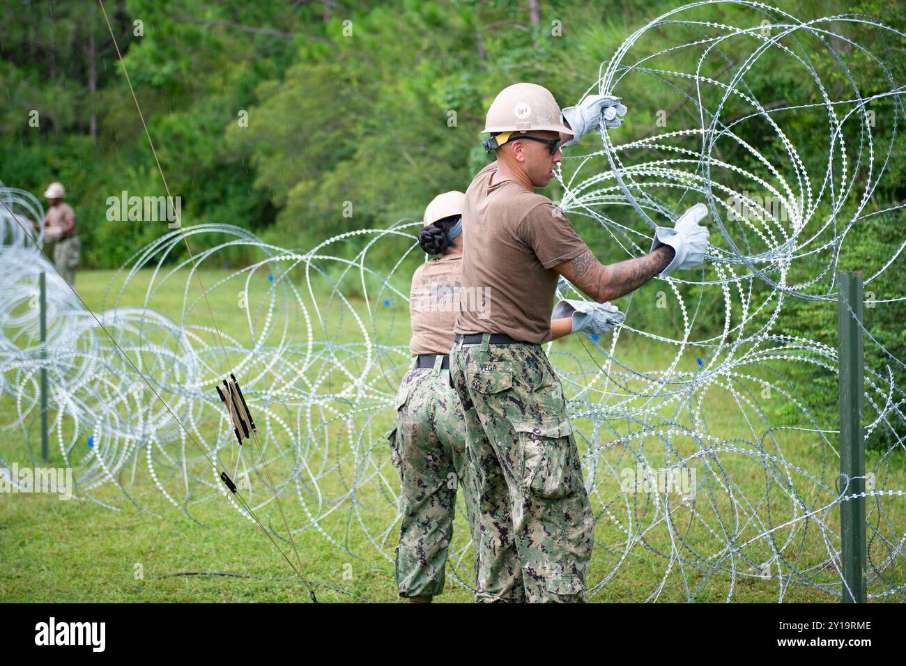 I marinai preparano un filo a fisarmonica per un posto di comando durante un'esercitazione sul campo Foto Stock