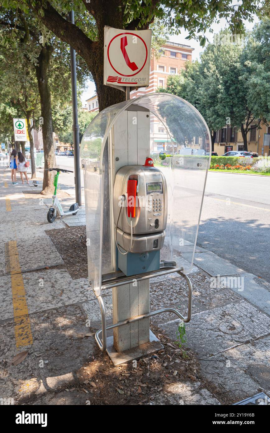 C'è ancora una cabina telefonica pubblica in una strada a Verona, in Italia. Foto Stock