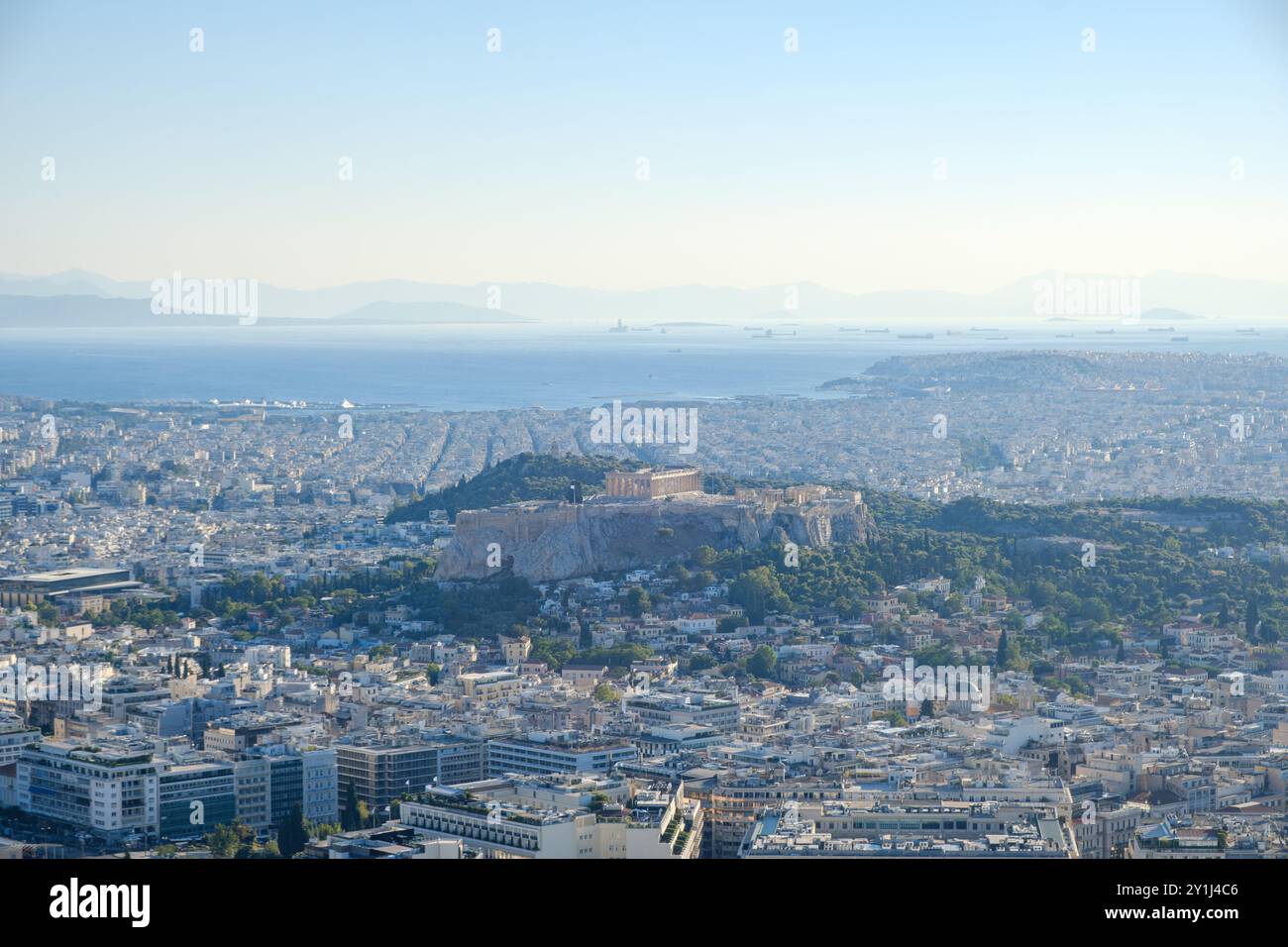 Vista panoramica di Atene, Grecia, con l'Acropoli ben visibile, che si affaccia sulla città e sul mare lontano. Foto Stock