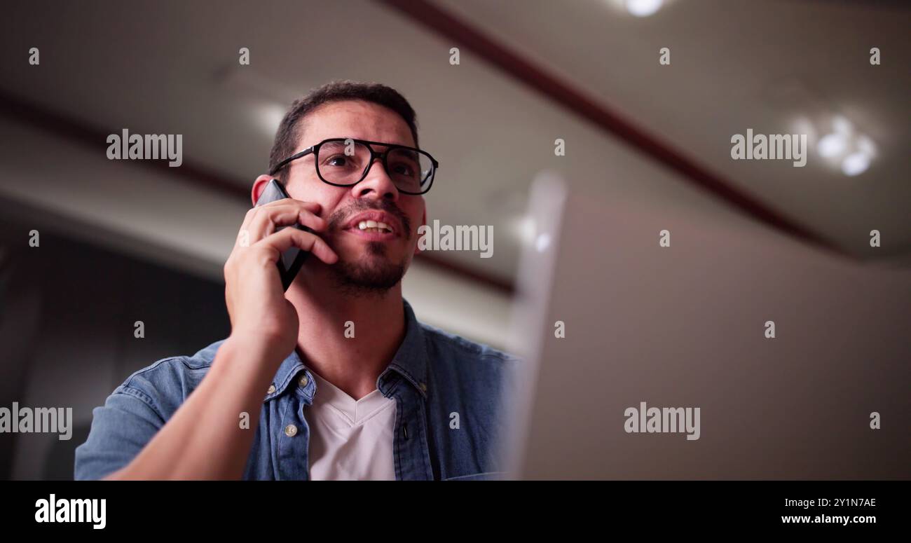 Portrait Of Young Happy Man Talking On Mobile Phone Foto Stock