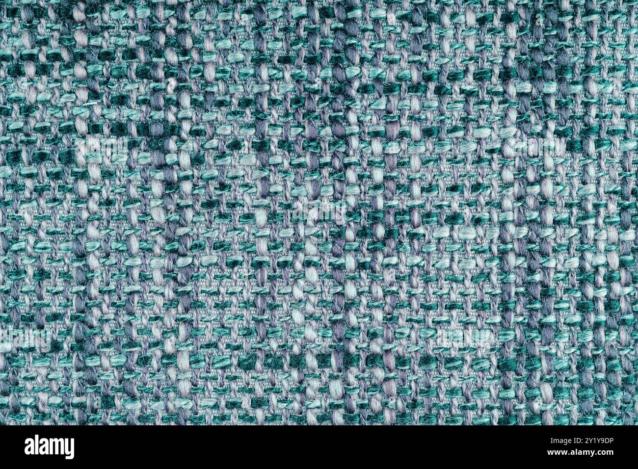 Trama in jacquard turchese con trama ruvida macro, primo piano. Panno melange di colore misto. Materiale per tessuti per la casa, tappezzeria e tende, dec Foto Stock