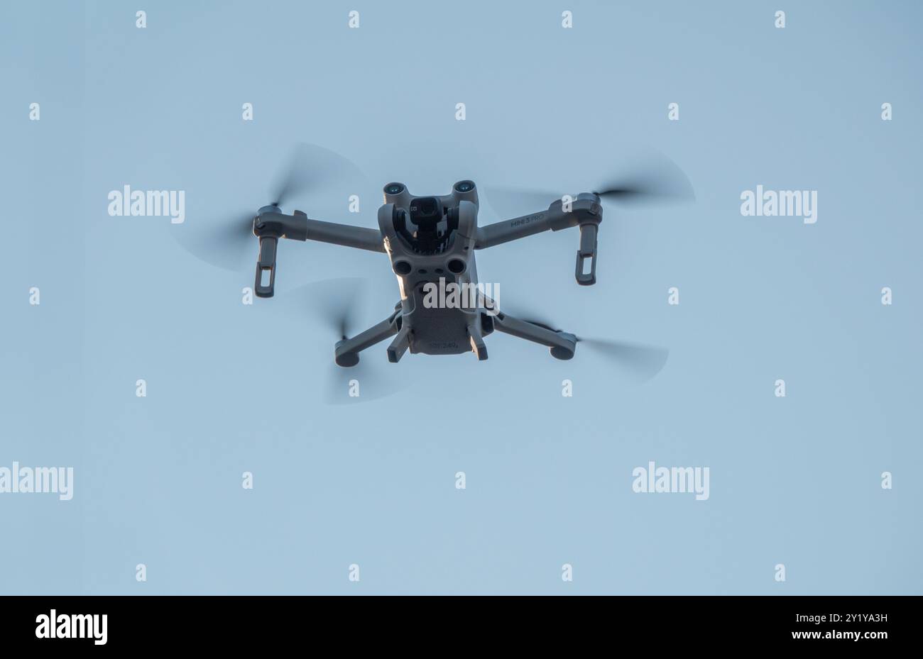 Drone con 4 eliche che girano in volo visto dal basso. Sfondo blu del cielo. Copenaghen, Danimarca - 6 settembre 2024. Foto Stock
