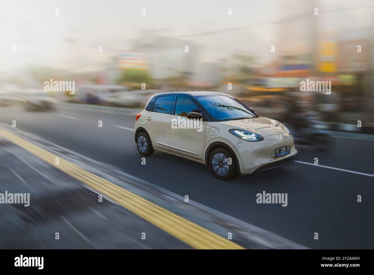 Balikpapan, Indonesia - 9 agosto 2024. Il movimento dinamico di questo veicolo elettrico e lo sfondo sfocato trasmettono un senso di velocità ed efficienza. Foto Stock