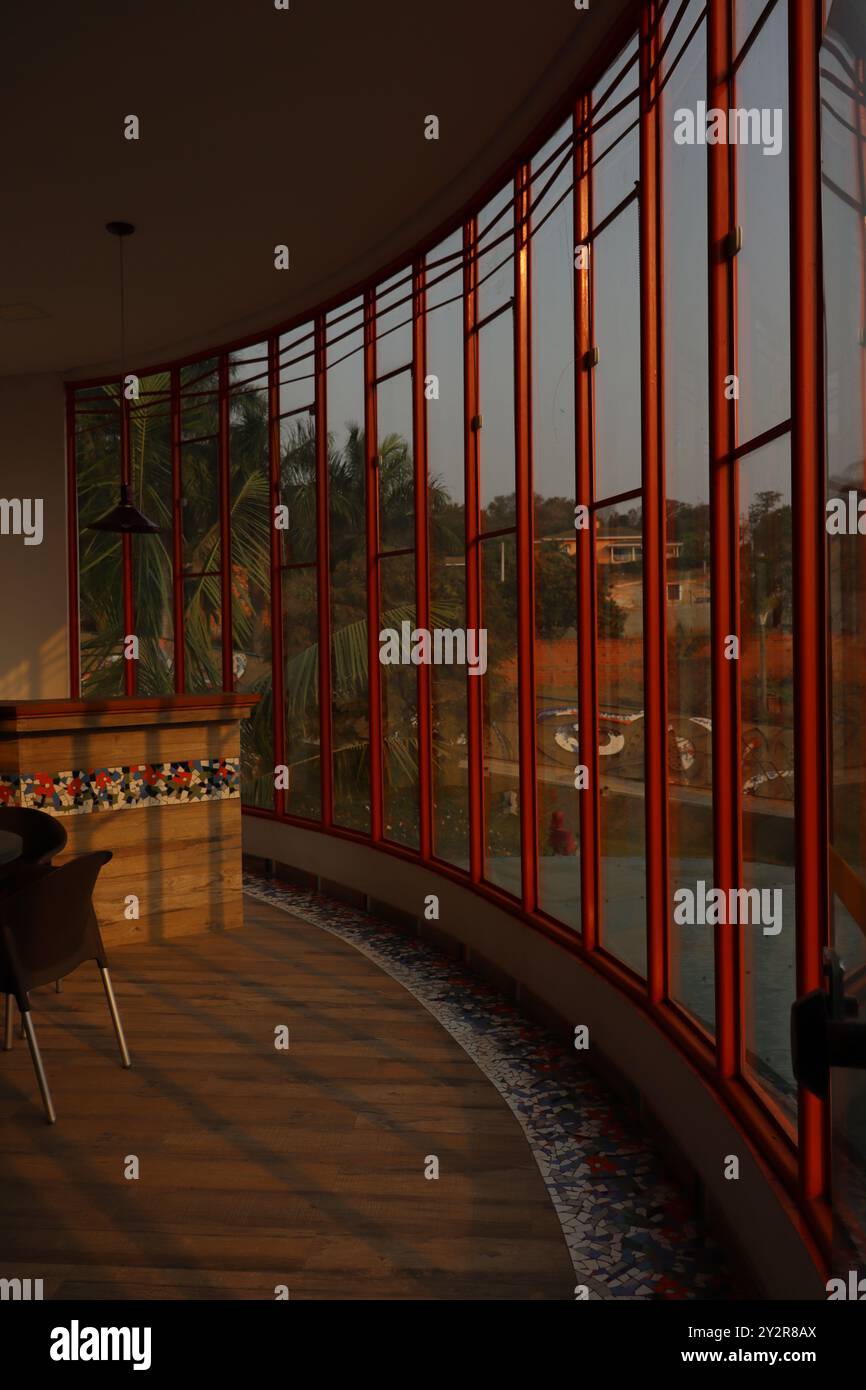 Vista di un pomeriggio di sole attraverso un pannello di vetro all'interno di una galleria d'arte. Nel terreno, possiamo vedere una striscia di frammenti, uno stile molto comune di piastrelle vecchie Foto Stock