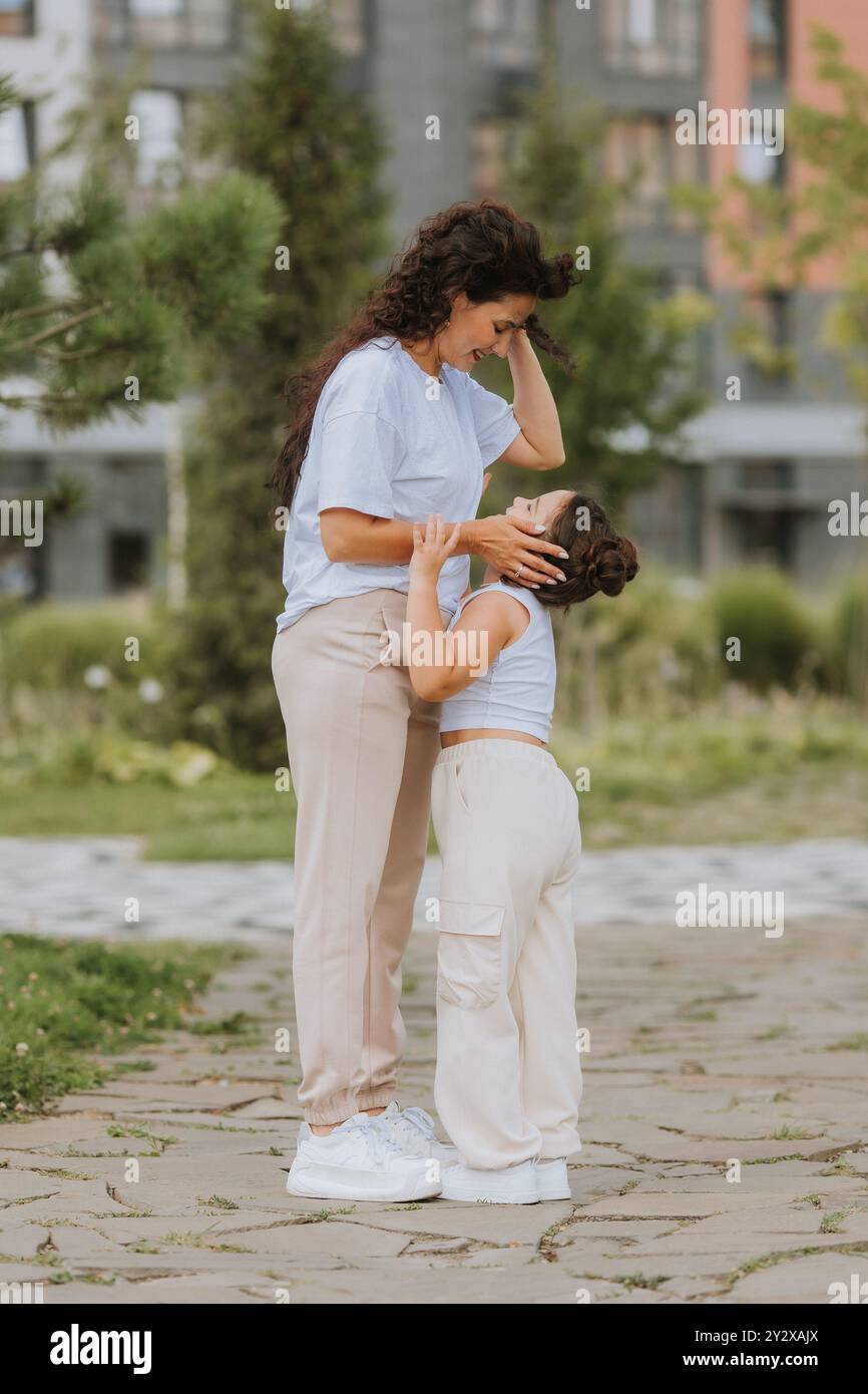 Mamma e figlia felici si rilassano nel parco cittadino. Foto di alta qualità Foto Stock