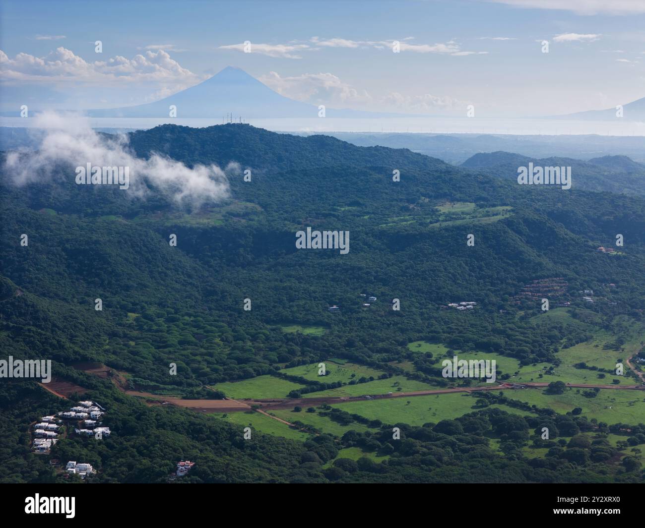 Panorama naturale della giungla tropicale con vista aerea del vulcano sullo sfondo Foto Stock