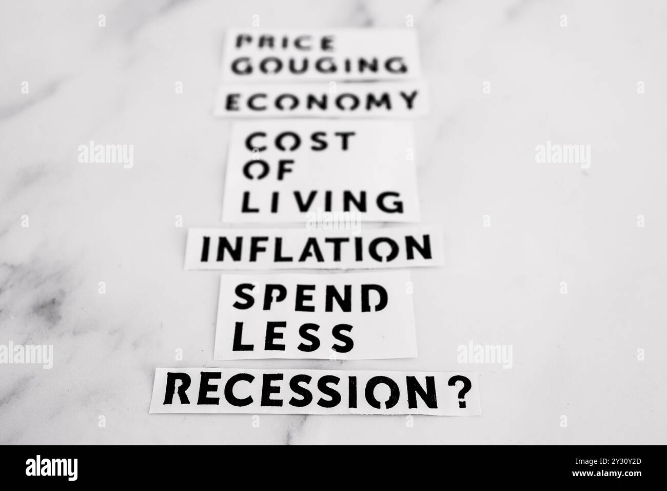 Immagine concettuale dell'inflazione e della recessione, i termini economici sulla scrivania in marmo si allontanano dalla telecamera Foto Stock Immagine concettuale dell'inflazione e della recessione, i termini economici sulla scrivania in marmo si allontanano dalla telecamera Foto Stock
