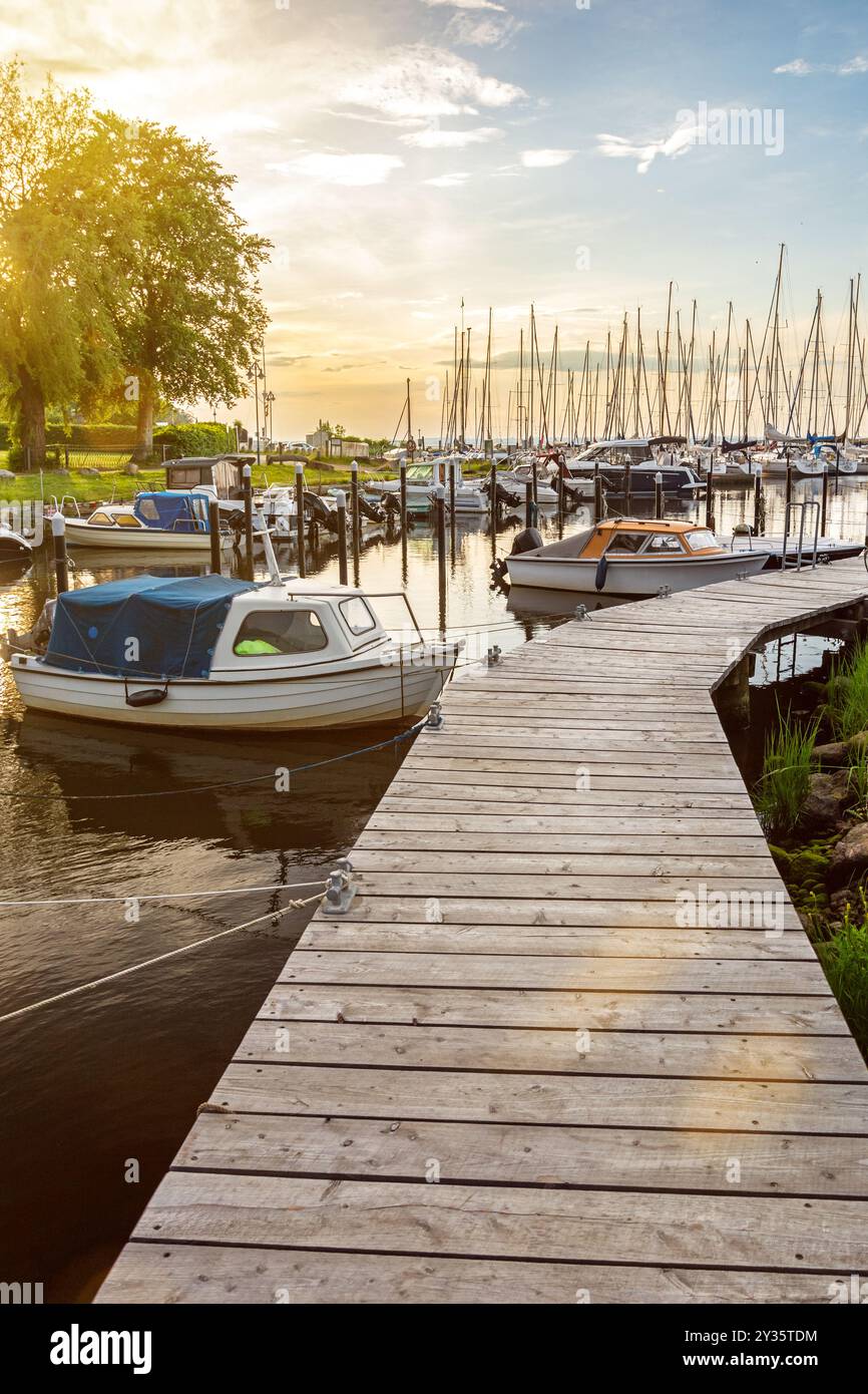 Barche al molo di Langballigau durante lo splendido tramonto sul Mar Baltico nella Germania settentrionale Foto Stock