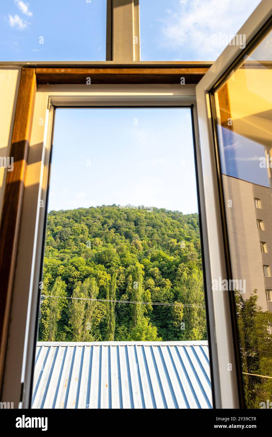 Vista della montagna sovrastata dalla finestra aperta nella soleggiata giornata estiva nella città di Dilijan, Armenia Foto Stock