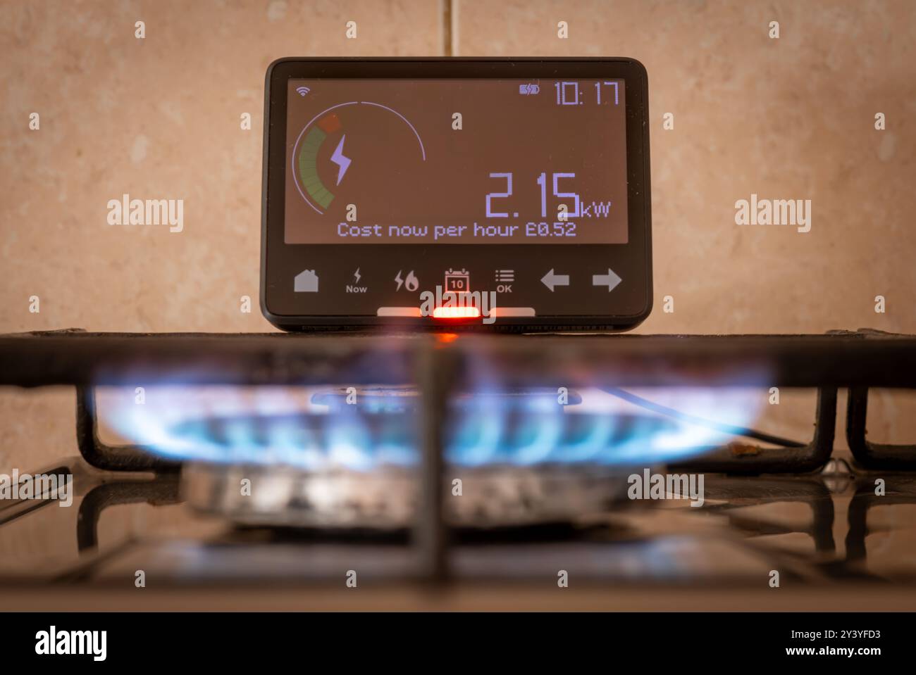 Un concetto di consumo energetico e di costo con un contatore energetico intelligente vicino a un fornello a gas. Foto Stock