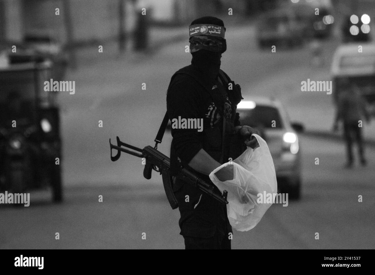 Gaza, Palestina. 12 maggio 2020. I membri delle Brigate Izz al-DIN al-Qassam, l'ala militare di Hamas, distribuiscono acqua e datteri nelle strade del quartiere Zaytoun a est della città di Gaza, prima della chiamata serale alla preghiera durante il Ramadan. I musulmani digiunano ogni giorno dall'alba al tramonto durante il mese santo del Ramadan, e rompono il loro digiuno all'ora della chiamata serale alla preghiera. Nella Striscia di Gaza, già vittima di un assedio paralizzante e di una recessione economica, le rigorose misure volte a mitigare la diffusione del COVID-19 hanno aggravato la disoccupazione, la povertà e le avverse Foto Stock