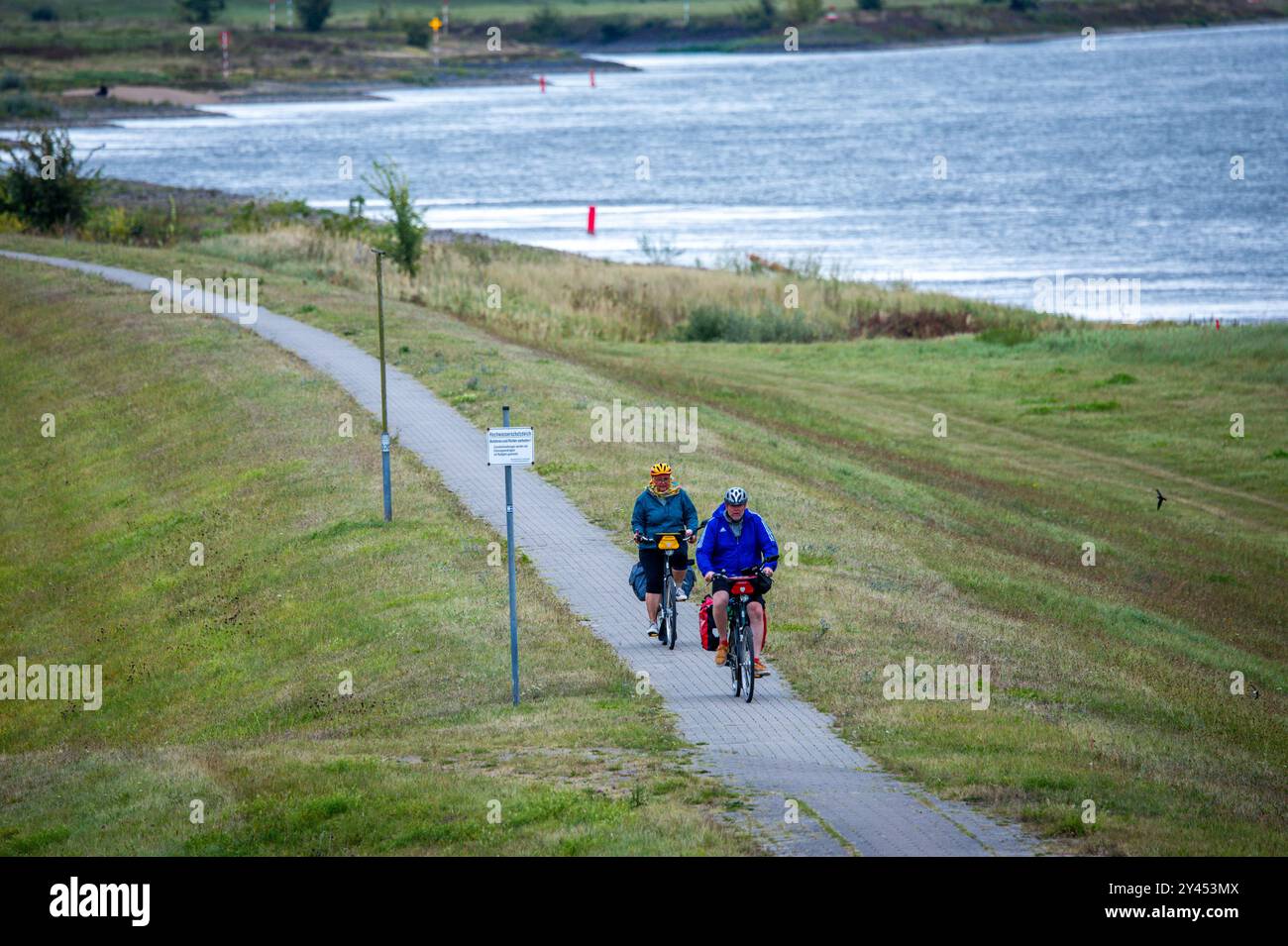 16 settembre 2024, Meclemburgo-Pomerania occidentale, Dömitz: I ciclisti sono fuori e in giro sulla pista ciclabile lungo l'Elba. In una conferenza stampa, il Ministero dell'ambiente del Meclemburgo-Vorpommern informa circa i preparativi per una prevista situazione di alluvione nella regione della valle dell'Elba nella Germania settentrionale nei prossimi giorni. Foto: Jens Büttner/dpa Foto Stock