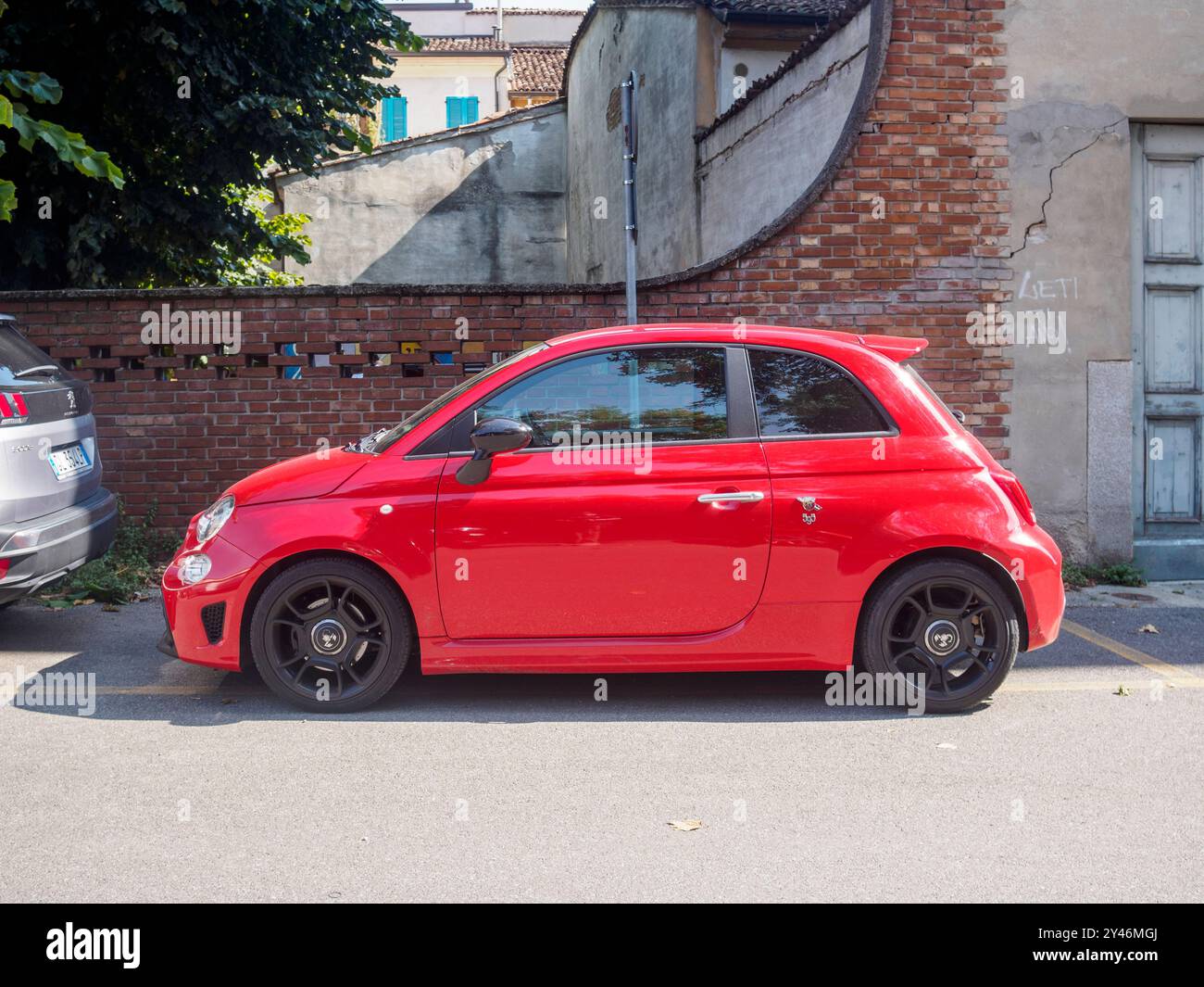 Cremona, Italia 31 agosto 2024 Una fiat 500 abarth rossa parcheggiata in strada in estate, che mostra il suo design sportivo e il suo patrimonio italiano Foto Stock