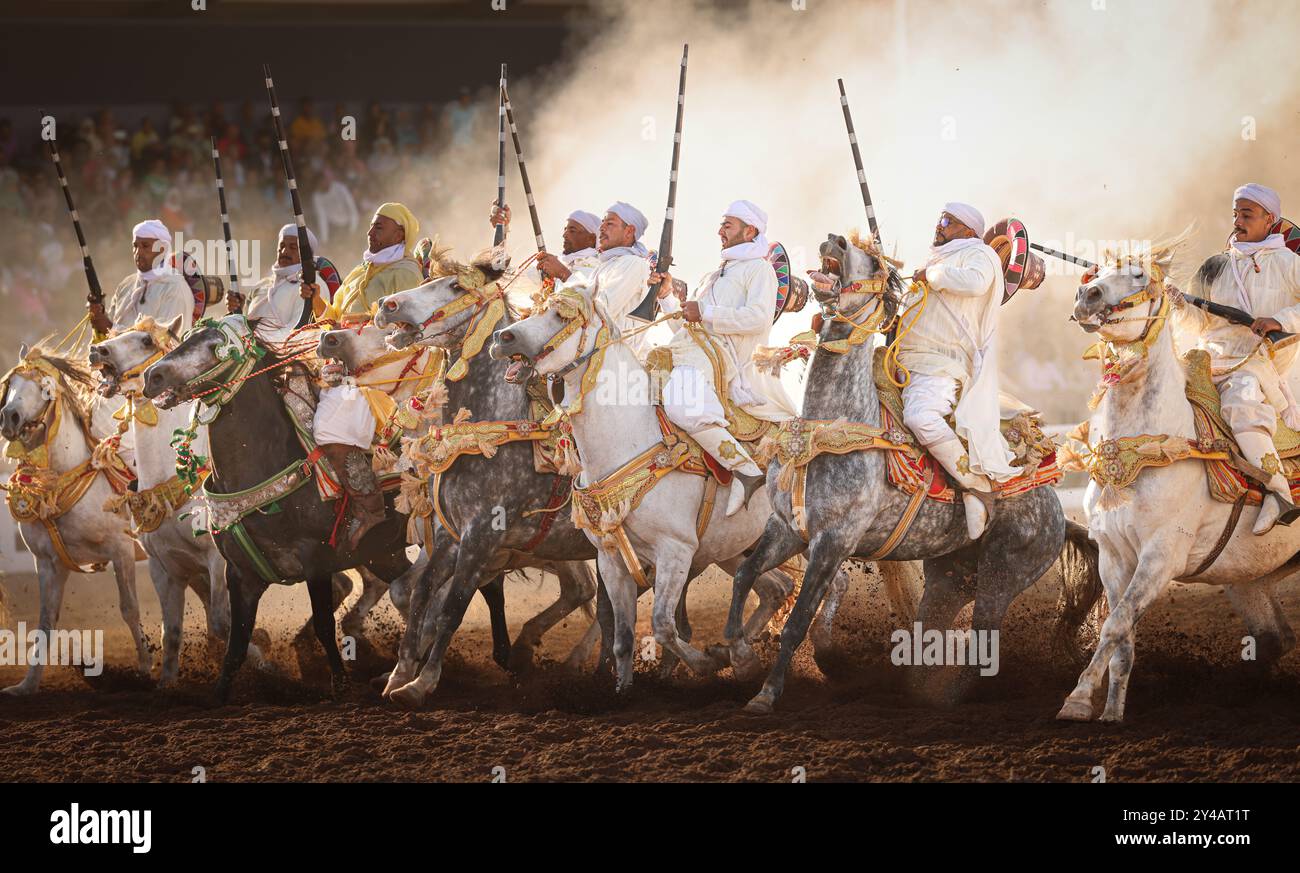 Nel cuore del Marocco, Fantasia brilla per i suoi colori vivaci e il suo potente display. Maestosi cavalli e cavalieri valorosi, avvolti da abiti vivaci, Foto Stock