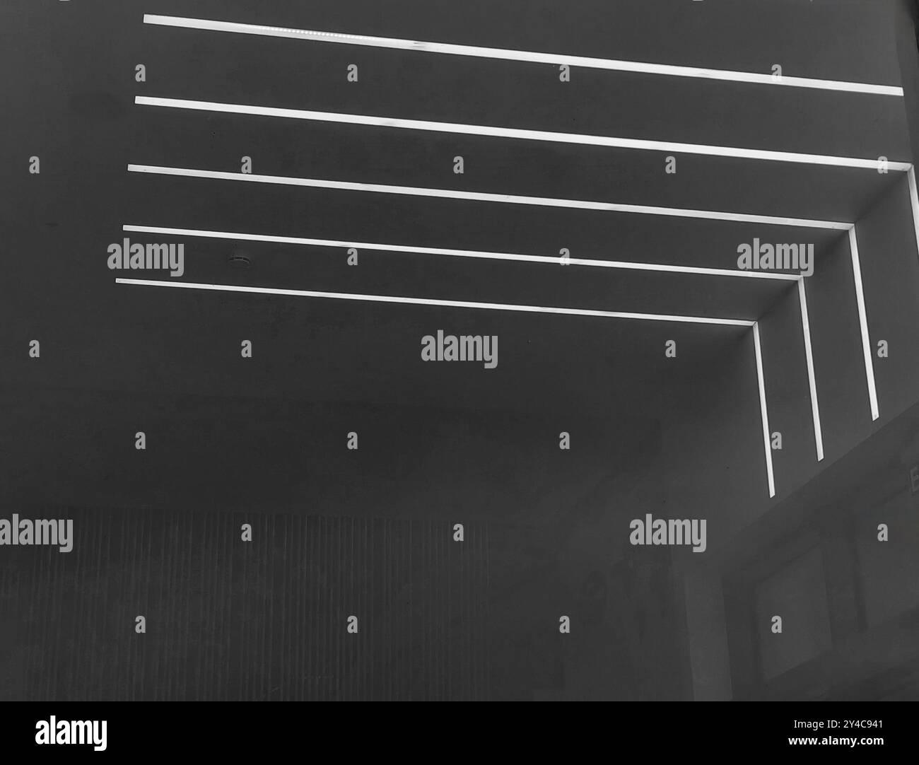 Soffitto luminoso moderno con motivo e texture in bianco e nero, sfondo scuro della parete, spazio negativo Foto Stock