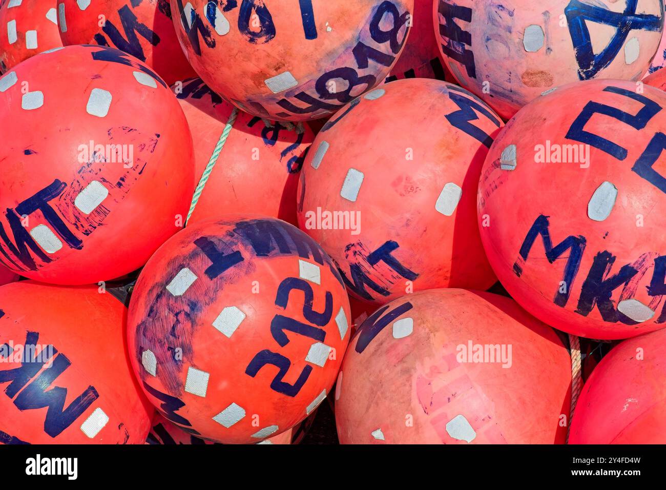 Primo piano di vecchie boe di plastica per gabbie di granchio a terra. Foto Stock