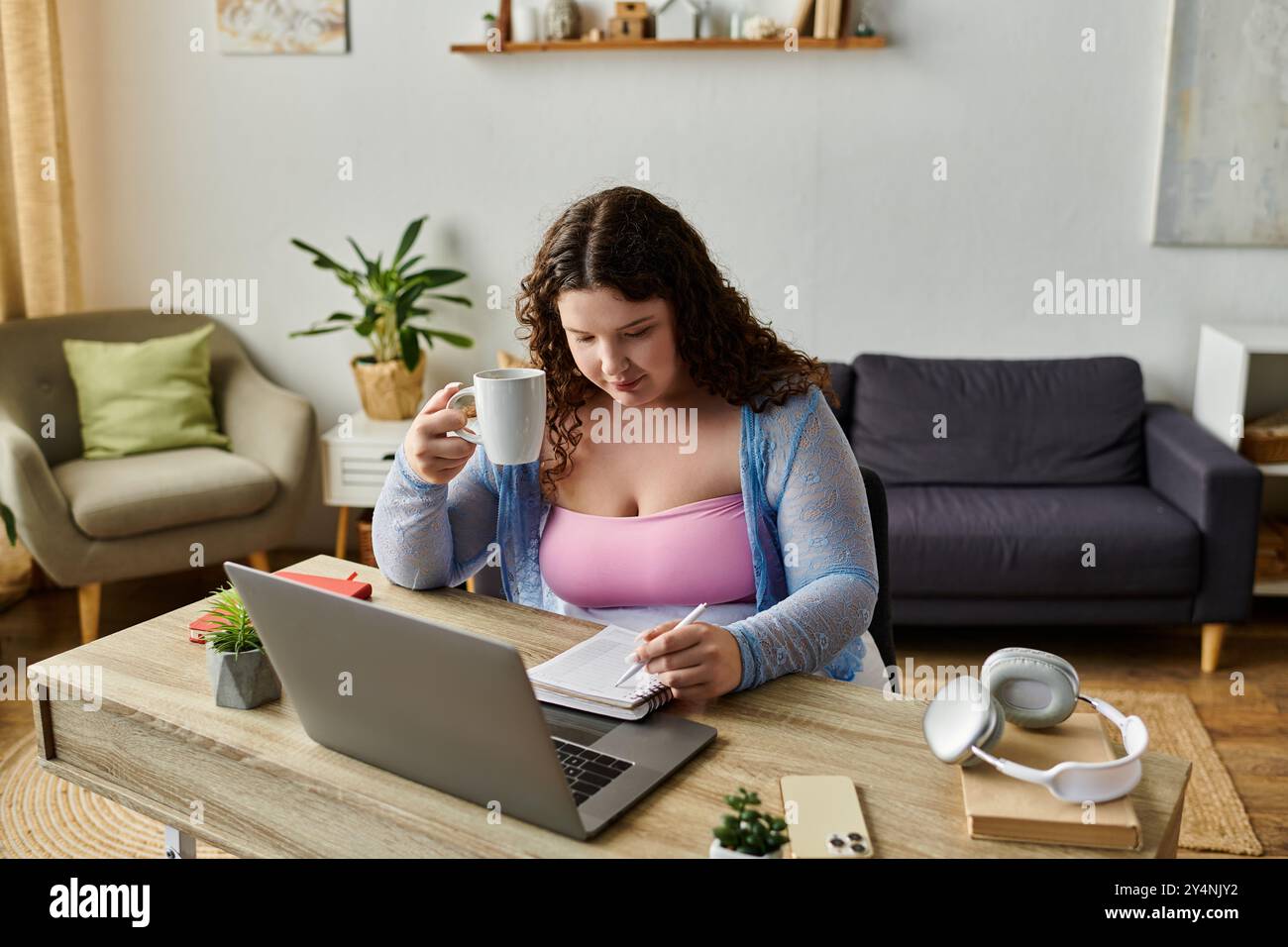 Donna che lavora duro con i capelli scuri che lavora a casa. Foto Stock