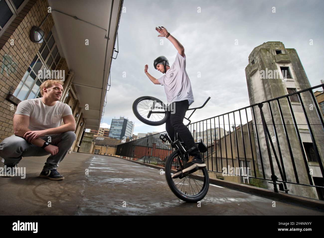Matti Hemmings esegue una acrobazia BMX "D Truck" su un balcone dell'edificio della Old Fire Station di Bristol. Foto Stock