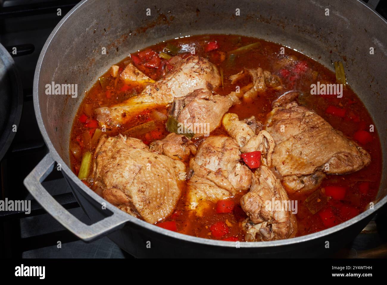 Una pentola di pollo allo stufato marrone, un classico piatto giamaicano Foto Stock