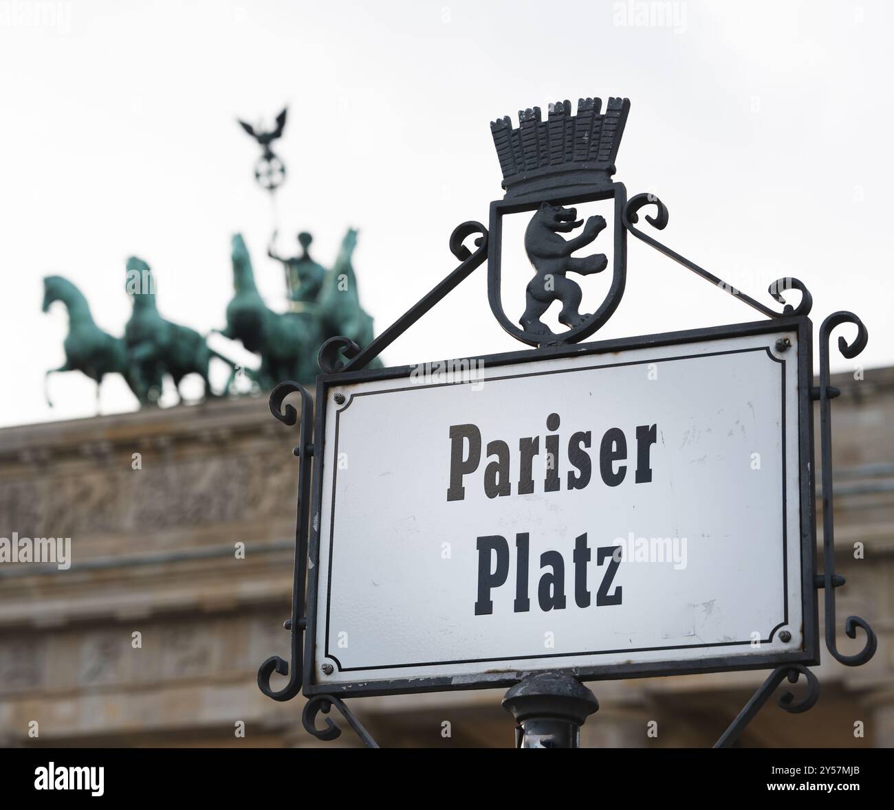 Un cartello stradale per Pariser Platz alla porta di Brandeburgo (Brandenburger Tor) a Berlino, Germania. Il cancello è visibile sullo sfondo. Foto Stock