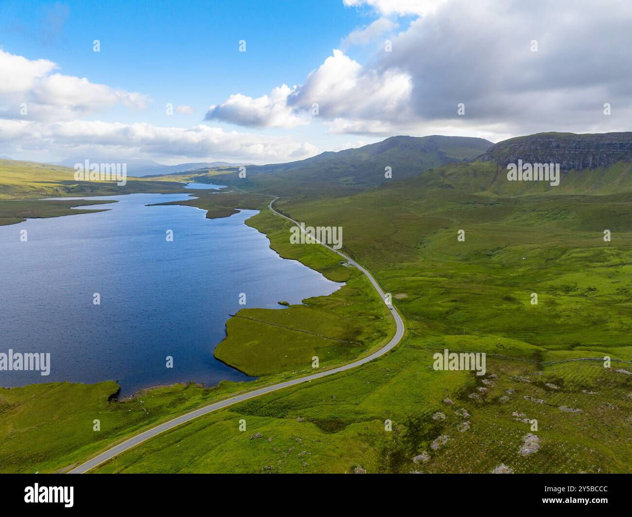 Il percorso panoramico North Coast 500 si snoda intorno a un lago nelle Highlands scozzesi vicino a Old Man of Storr nell'Isola di Skye, Scozia Foto Stock