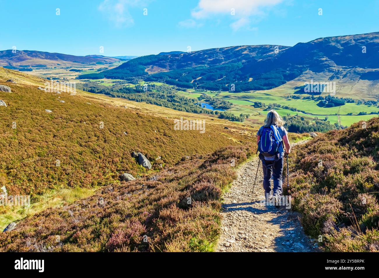 Un camminatore sul sentiero che scende dal Loch Brandy a Glen Clova, Angus, Scozia Foto Stock