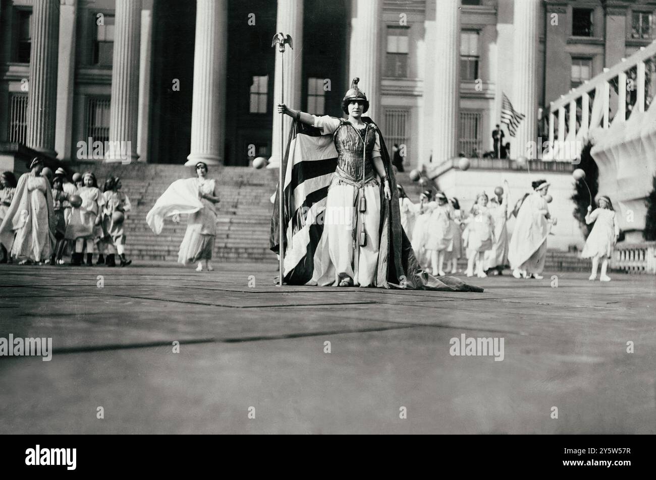 Foto d'epoca dell'attrice tedesca Hedwig Reicher che indossa il costume di "Columbia" con altri partecipanti al concorso di suffragio in piedi sullo sfondo di fronte al Treasury Building, 3 marzo 1913, Washington, D.C. Foto Stock