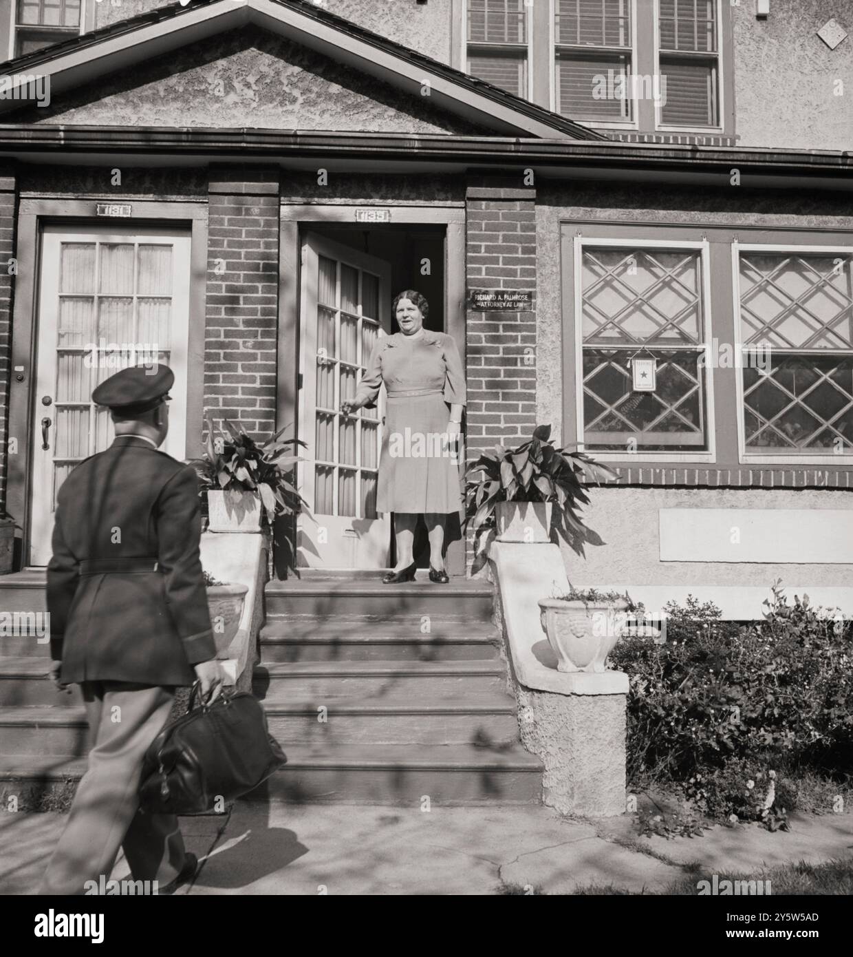 America degli anni '1940 Una sezione della città in gran parte abitata da finlandesi-americani vicino alla 39th Street e alla 8th Avenue conosciuta come Finn Town. Il tenente Palmrose saluta sua madre mentre torna a casa in ferie. Padre Palmrose è un avvocato e anche un costruttore edile. Costruì la sua casa e altre nello stesso isolato. Brooklyn, New York. Ottobre 1942 Foto Stock