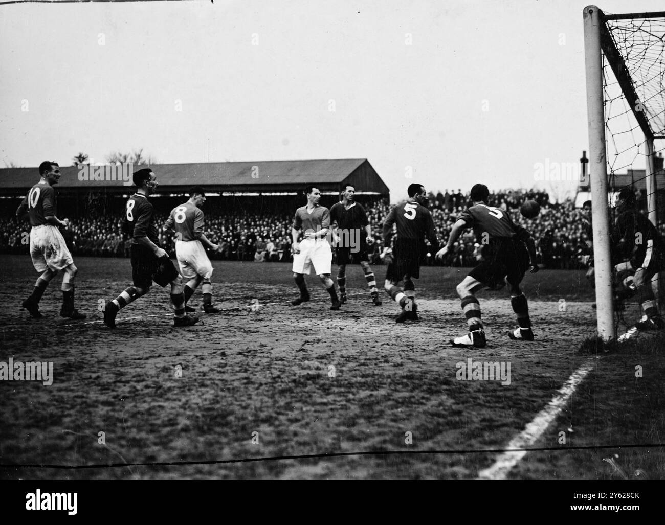 Il Colchester United, uno dei due club non-League che ha raggiunto il terzo turno della F.A. Cup, ha dato la sensazione di una giornata segnando una meritata vittoria per 1-0 contro la loro Division One degli avversari, Huddersfield Town, a Colchester questo pomeriggio. L'immagine mostra: Una mischia segue un calcio d'angolo alla fine di Colchester Tutti gli occhi sono puntati sulla palla mentre Wright, nella porta di casa, si prepara a salvare. 10 gennaio 1948 Foto Stock