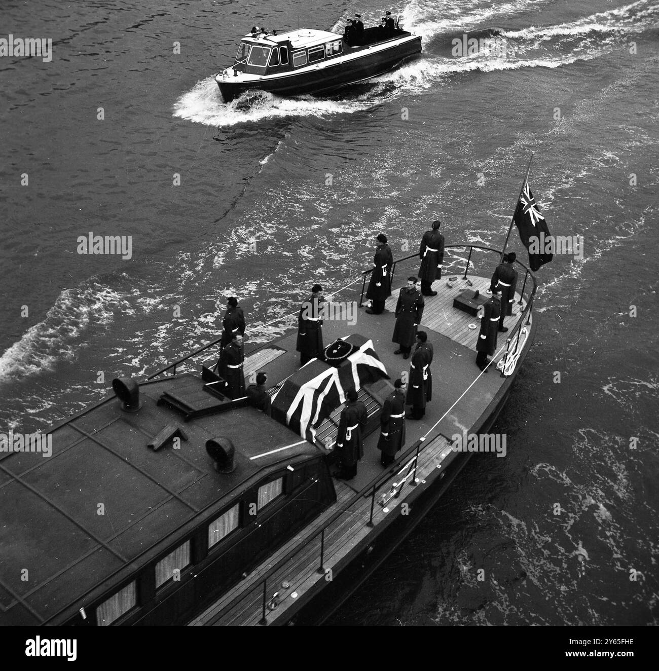 L' ultimo viaggio sul fiume in piedi rigidamente all' attenzione , il partito portatore delle Grenadier Guards , circonda la bara drappeggiata con la bandiera di Sir Winston Churchill mentre lo statista di 90 anni fu trasportato sul Tamigi a bordo del varo del porto di Londra , Havengore , durante i funerali di stato . 30 gennaio 1965 Foto Stock