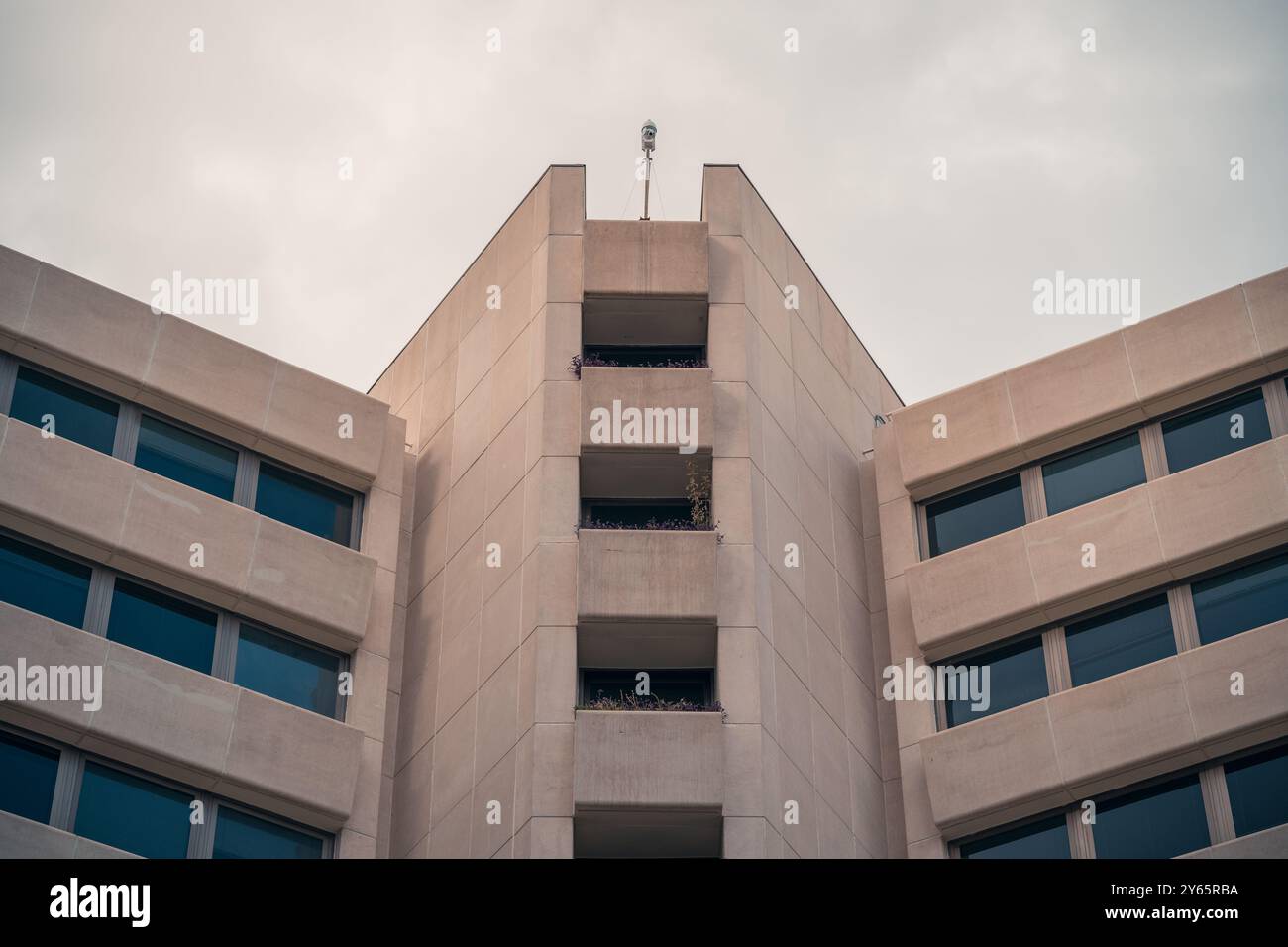 Vista simmetrica di un edificio moderno nell'AZCA, il quartiere finanziario di Madrid, che presenta un'architettura minimalista con cieli limpidi. Foto Stock