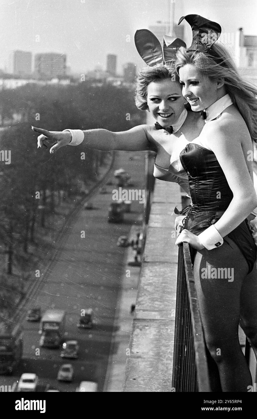 Godendosi il sole primaverile e la vista panoramica di Hyde Park dal tetto del Playboy Club nel parco Lane ci sono Bunny Girls Julie (a sinistra) e Nicky . Maggio 1968 Foto Stock