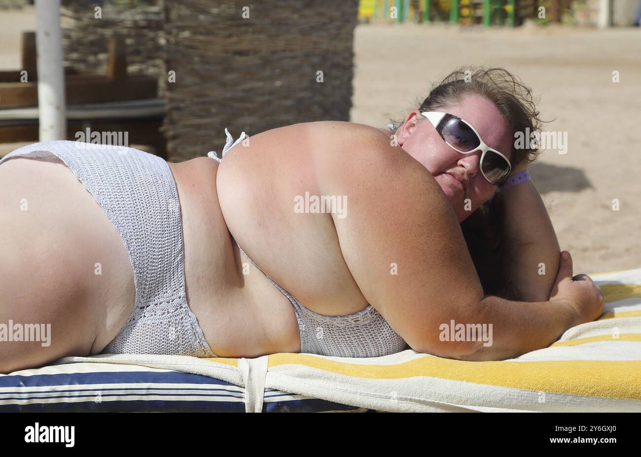 Vacanza, donna sovrappeso sdraiata sulla spiaggia Foto Stock Vacanza, donna sovrappeso sdraiata sulla spiaggia Foto Stock