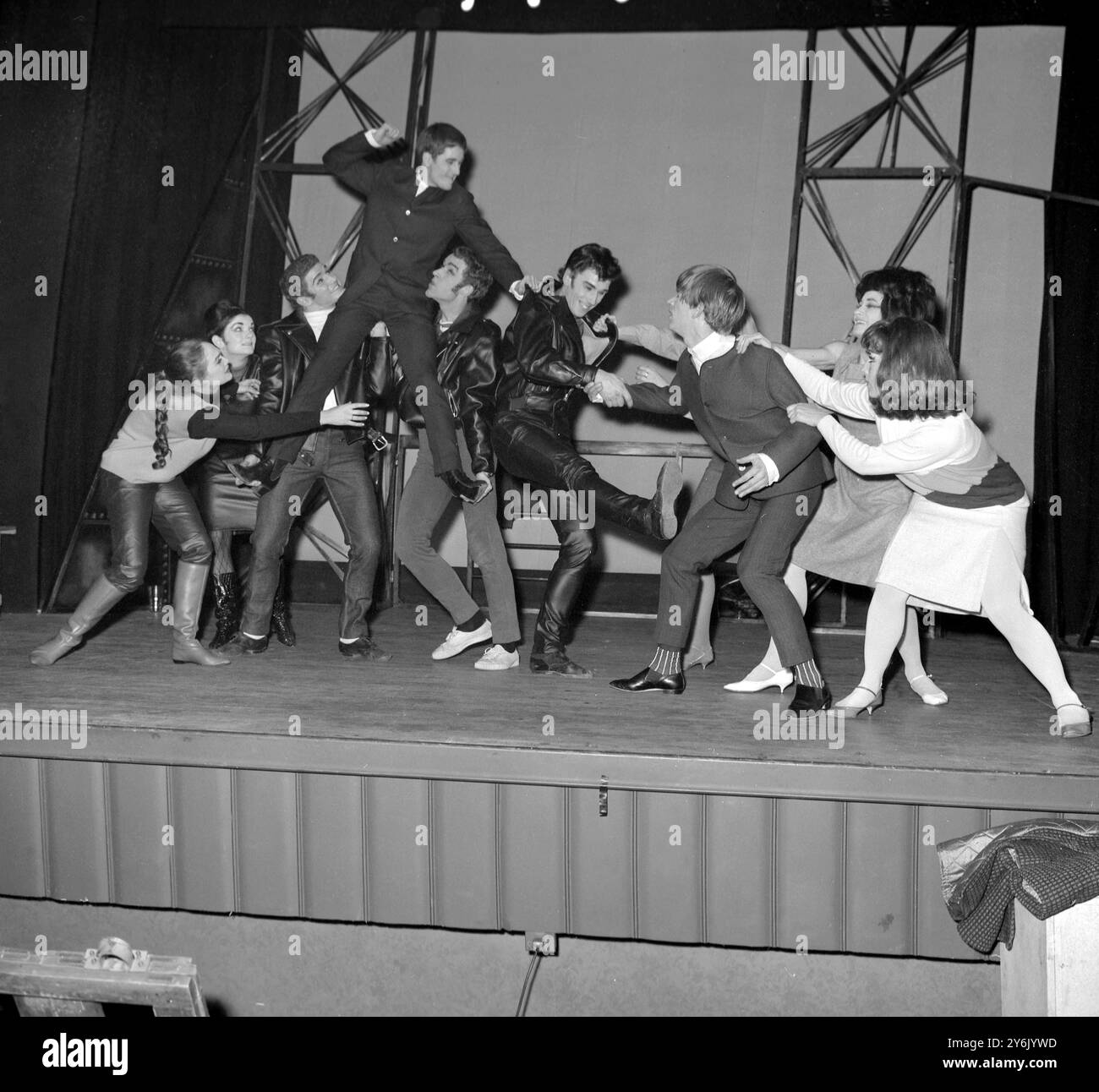 Quello che sembra essere un tussle di strada fa infatti parte di un nuovo balletto chiamato Mods and Rockers , coreografato da Peter Darrell sulla musica di John Lennon , Paul McCartney e George Harrison del gruppo pop The Beatles . Questa scena è raffigurata durante la prova generale di stasera al Prince Charles Theatre di Londra . Il balletto With - IT è il momento culminante del programma presentato dalla Western Theatre Ballet Company per una stagione natalizia che aprirà il 18 dicembre . La compagnia lo chiama balletto per Beats. 16 dicembre 1963 Foto Stock