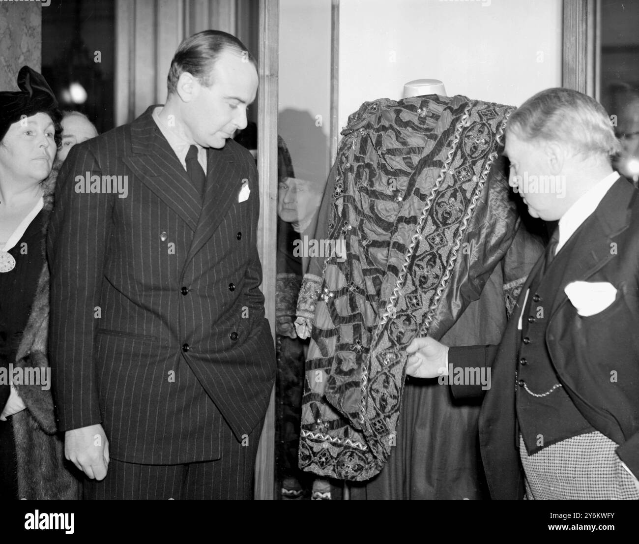 Reliquie di Irving in mostra a Lancaster House, St James. Laurence Irving (a sinistra), nipote del grande attore, e Sir John Martin-Harvey che ispeziona le vesti Becket, il mantello e il mantello, indossati da Irving nell'ultima rappresentazione della sua carriera a Bradford. 7 febbraio 1938 Foto Stock