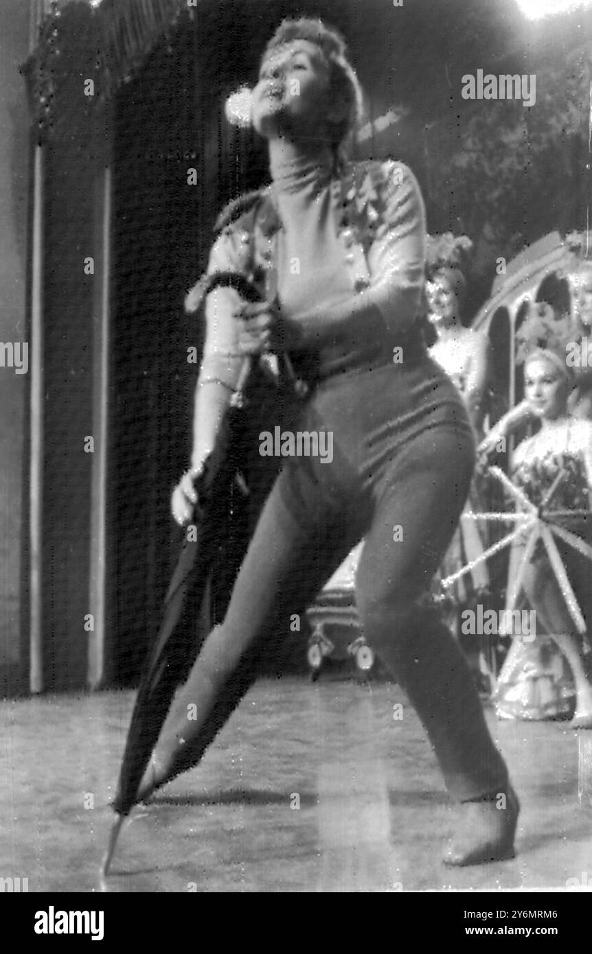 Hollywood, l'attrice statunitense Debbie Reynolds torna a girare dopo una recente serie di riprese con un'eccitante e torrida routine di tendenza che ha gli extra che riscuotono sul set. Debbie di recente e' dovuta andare in ospedale per un coagulo di sangue sul ginocchio. 14 febbraio 1959 Foto Stock