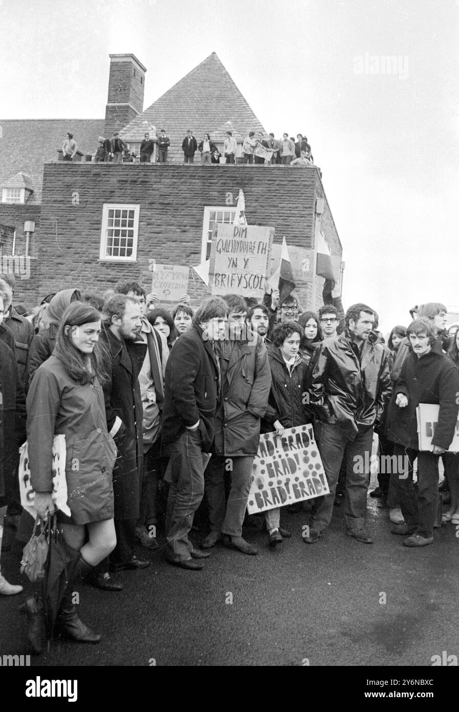 Gli studenti della società gallese manifestano nel 1969 contro una visita del principe di Galles ad Aberystwyth, dove il principe Carlo avrebbe avuto una squadra universitaria. Sul tetto sono presenti studenti lealisti Foto Stock