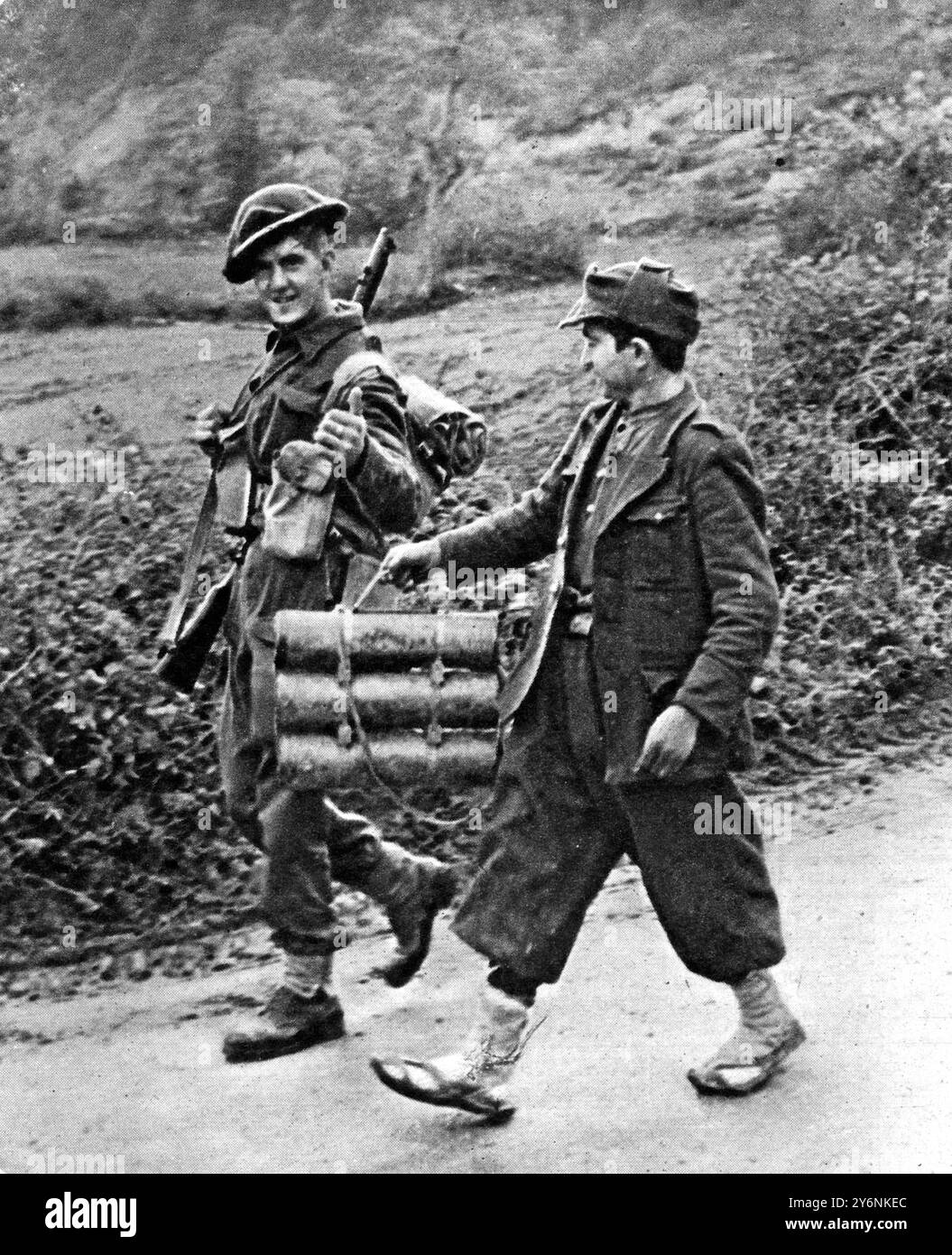 Operazioni sul fronte della Quinta e dell'Ottava Armata, guerra in condizioni di fango e terreno. Un ragazzo italiano sul fronte Sangro maneggia con affetto bombe mortaio per il signor Tommy Atkins, dicembre 1943 Foto Stock