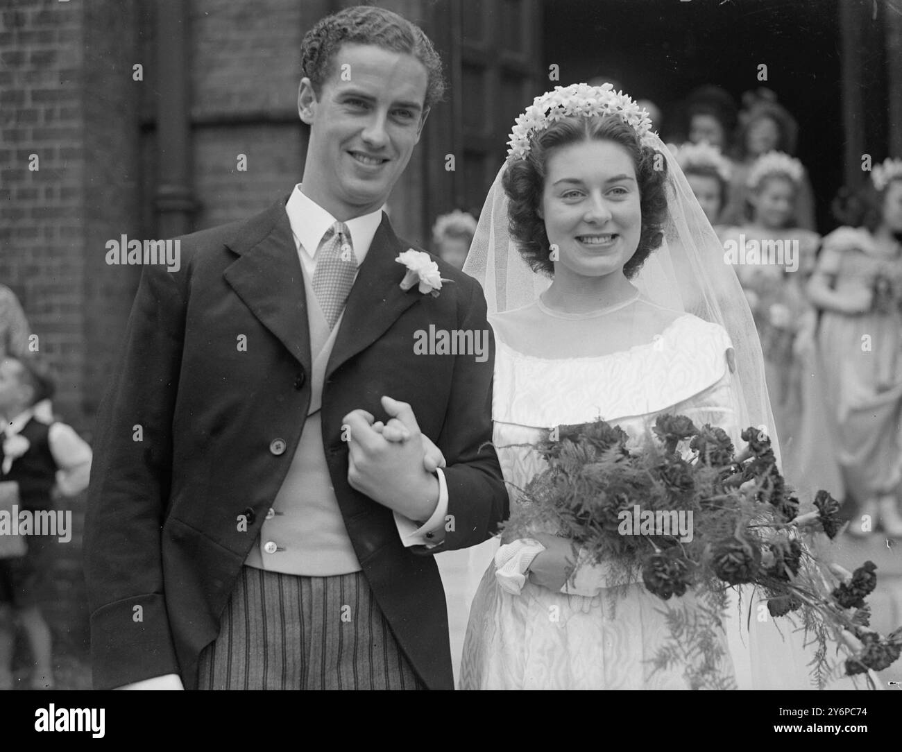 OH, CHE BELLA GIORNATA! Il cast di due importanti musical londinesi che forniscono le stelle di una scena di nozze reale quando Miss Gwen Overton, 18 anni, era sposata con Mr. Clive Stock , 22 , presso Emanuel Church , West Hampstead . Londra . La sposa e' un membro dell'Oklahoma! Compagnia al Drury Lane Theatre. Sig. Stock , ora apparso in Tough at the Top all' Adelphi Theatre , incontrò Miss Overton quando era membro dell' Oklahoma ! ' Compagnia la coppia non ha tempo per una luna di miele - entrambi appaiono sul palco fino a notte. L'IMMAGINE MOSTRA:- la sposa e lo sposo leavin Foto Stock