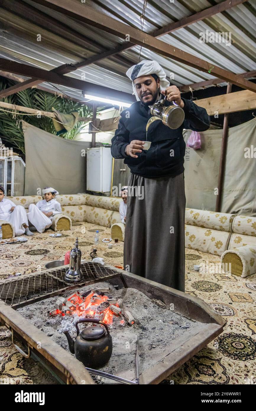 NAJRAN, ARABIA SAUDITA - 27 NOVEMBRE 2021: Membro della tribù Yam che versa caffè a Najran, Arabia Saudita Foto Stock